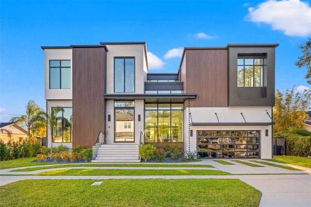 modern home with a garage and a front lawn