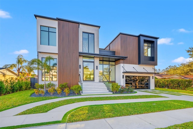 contemporary home with a garage and a front yard