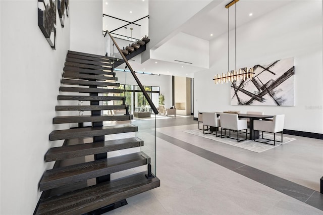 staircase featuring a high ceiling