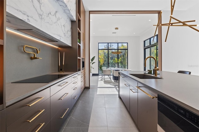 kitchen featuring sink, tasteful backsplash, black appliances, dark tile patterned flooring, and decorative light fixtures