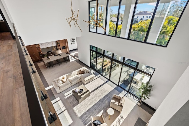living room featuring hardwood / wood-style flooring and a towering ceiling