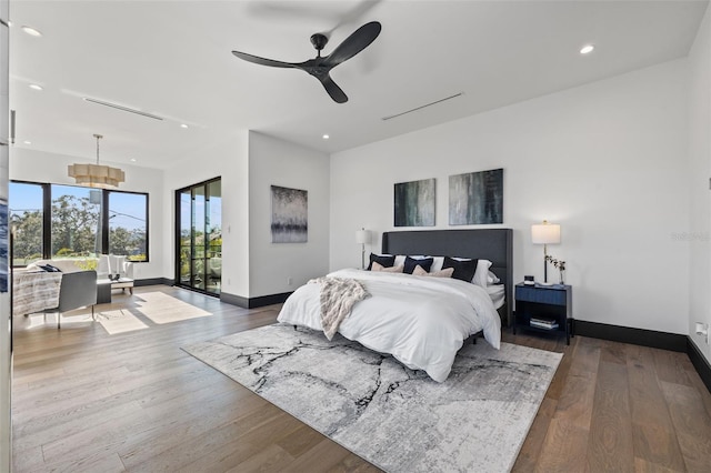 bedroom with hardwood / wood-style floors, access to outside, and ceiling fan