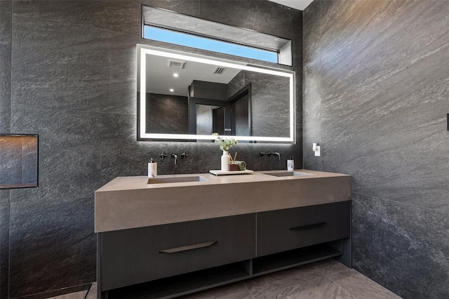 bathroom featuring vanity and tile walls