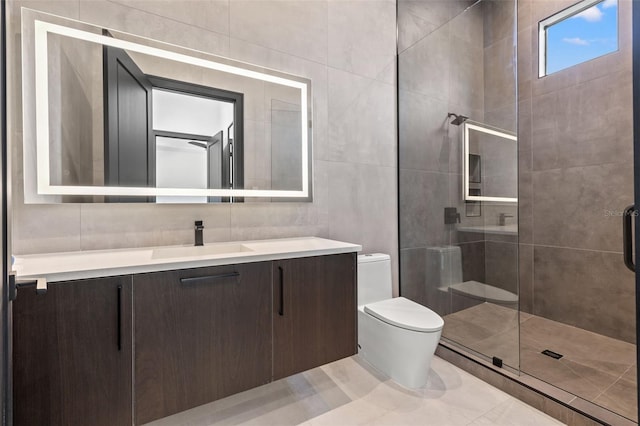 bathroom featuring tile walls, tile patterned flooring, vanity, an enclosed shower, and toilet