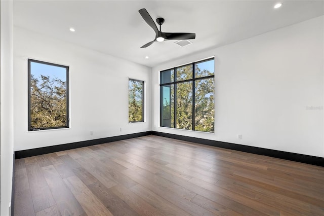 empty room with wood-type flooring and ceiling fan