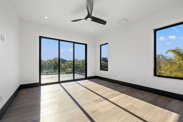 unfurnished room with hardwood / wood-style flooring and ceiling fan