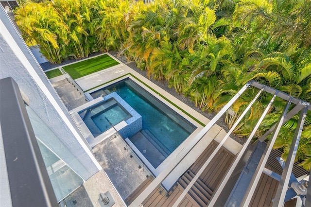 view of swimming pool featuring an in ground hot tub