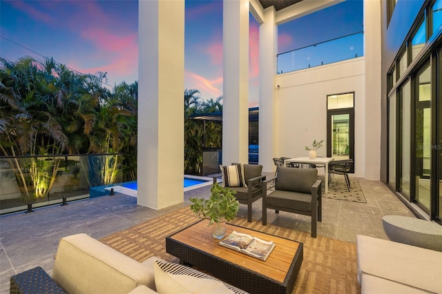 patio terrace at dusk featuring outdoor lounge area