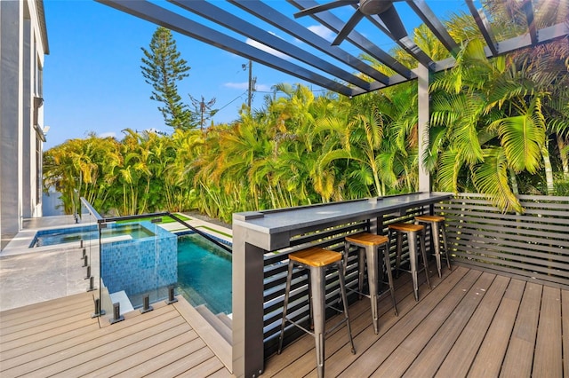 deck with a pergola and exterior bar
