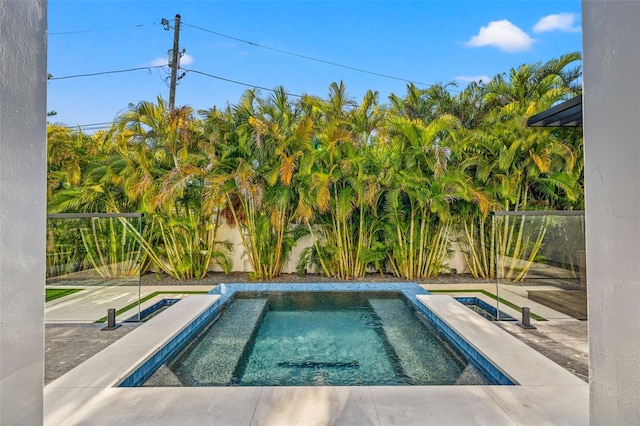 view of swimming pool featuring an in ground hot tub
