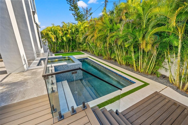 view of swimming pool with an in ground hot tub and a patio area