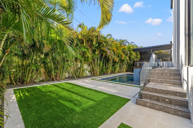 view of swimming pool featuring a yard and a patio