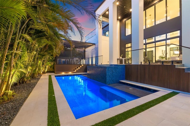 view of pool at dusk
