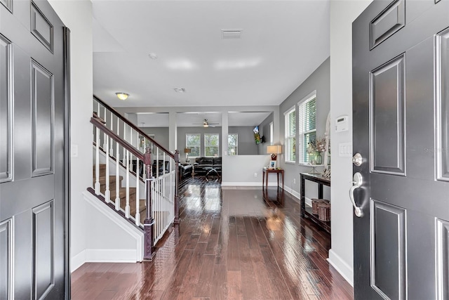 foyer entrance with dark hardwood / wood-style flooring and ceiling fan