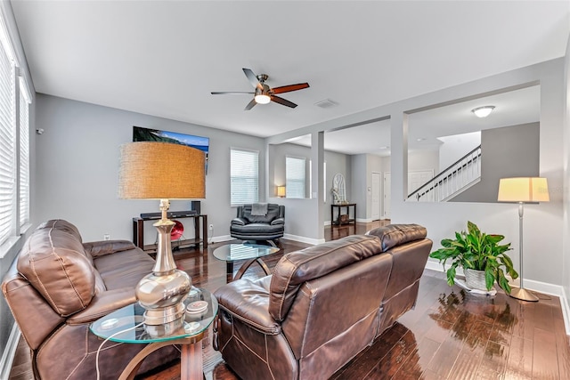 living room with dark wood-type flooring and ceiling fan