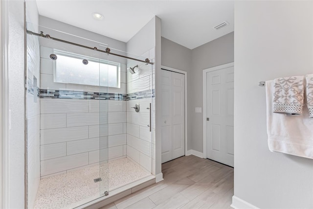 bathroom with a shower with shower door