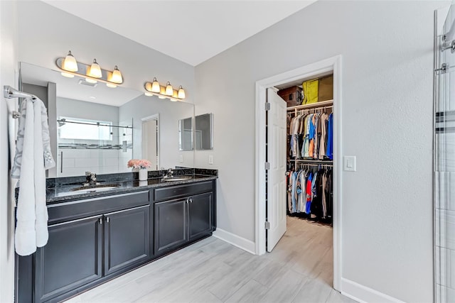 bathroom featuring hardwood / wood-style flooring, vanity, and an enclosed shower