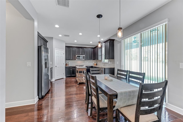 dining room with dark wood-type flooring and sink