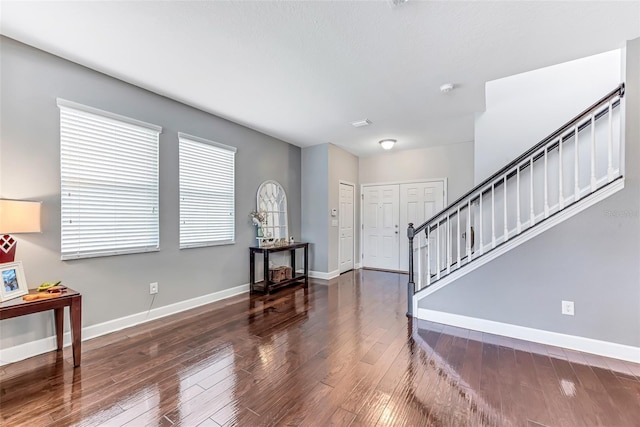 foyer with dark hardwood / wood-style floors