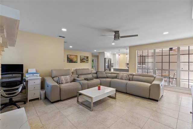 living room featuring light tile patterned floors and ceiling fan