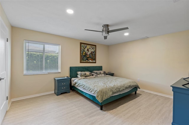 bedroom with ceiling fan and light hardwood / wood-style flooring