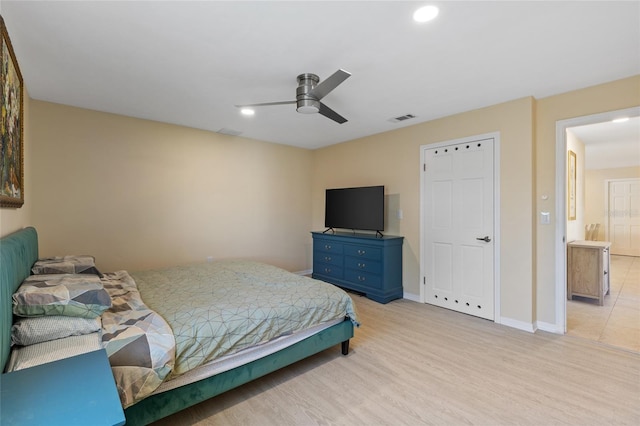 bedroom with ceiling fan and light hardwood / wood-style floors