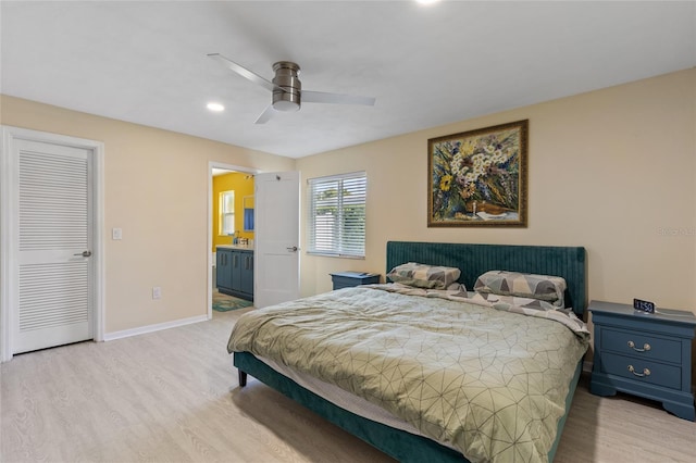 bedroom featuring light hardwood / wood-style floors, connected bathroom, ceiling fan, and a closet