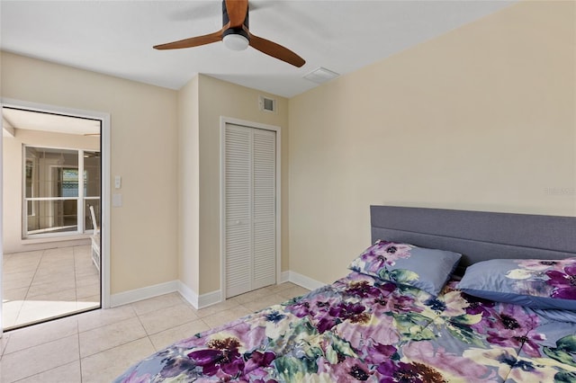 bedroom featuring ceiling fan, a closet, and light tile patterned floors