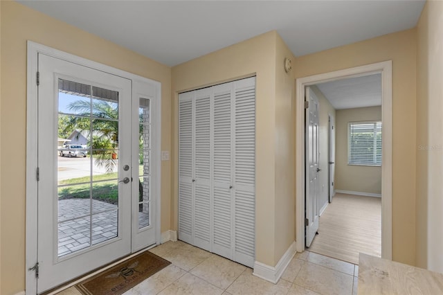 doorway to outside with light tile patterned floors