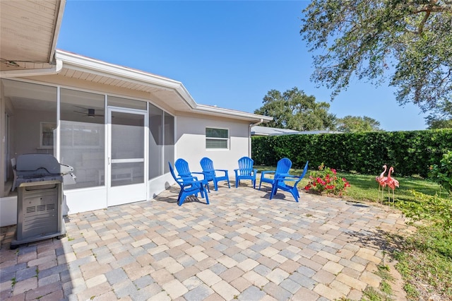 view of patio / terrace with grilling area and a sunroom