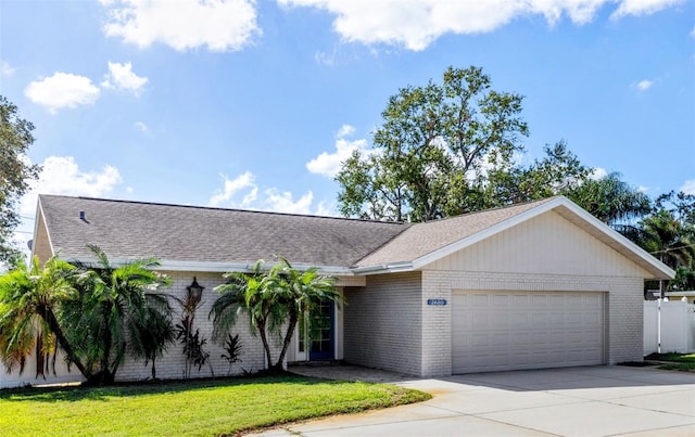 ranch-style house with a garage and a front yard