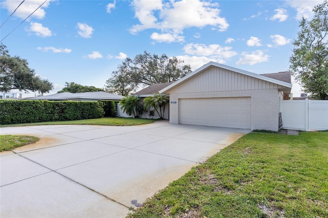 single story home featuring a garage and a front yard