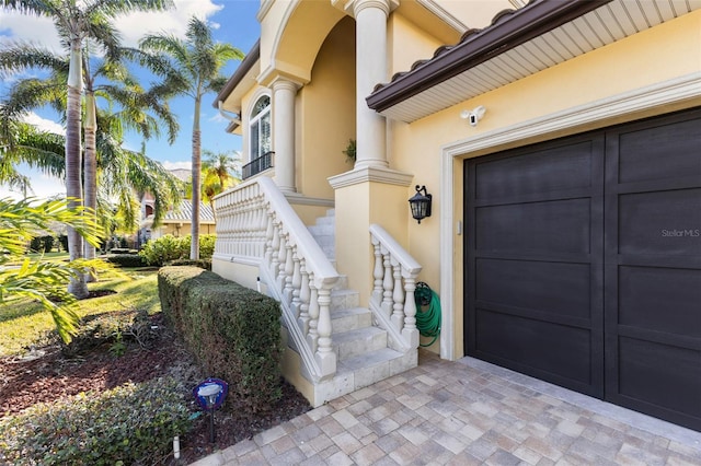 doorway to property with a garage