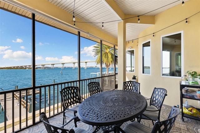 sunroom with a healthy amount of sunlight and a water view