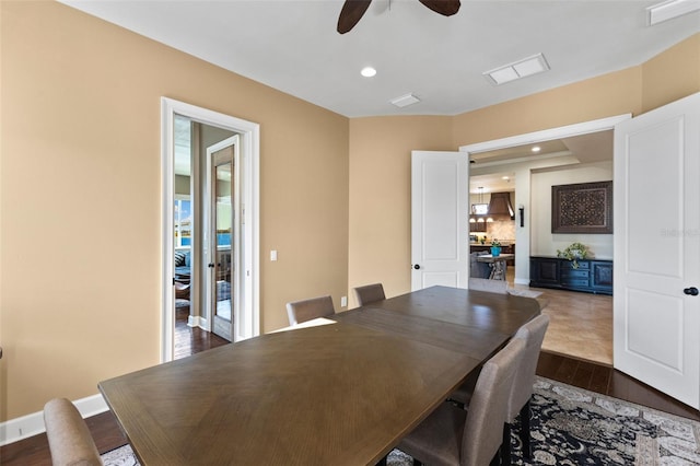 dining space with ceiling fan and dark hardwood / wood-style flooring