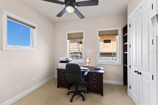 office featuring light carpet and ceiling fan