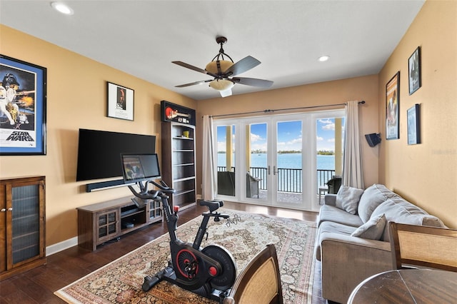 living room featuring dark wood-type flooring, ceiling fan, and french doors