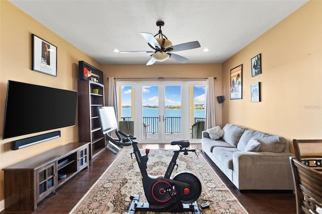 living room with french doors, ceiling fan, and dark hardwood / wood-style flooring