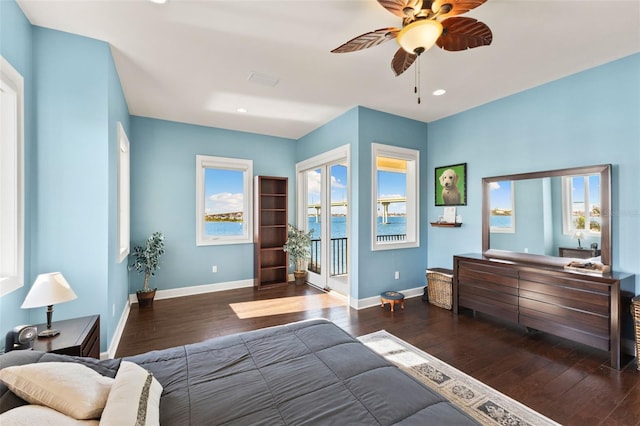 bedroom featuring multiple windows, dark wood-type flooring, access to outside, and ceiling fan