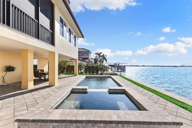 view of swimming pool with a water view, an in ground hot tub, and a patio area