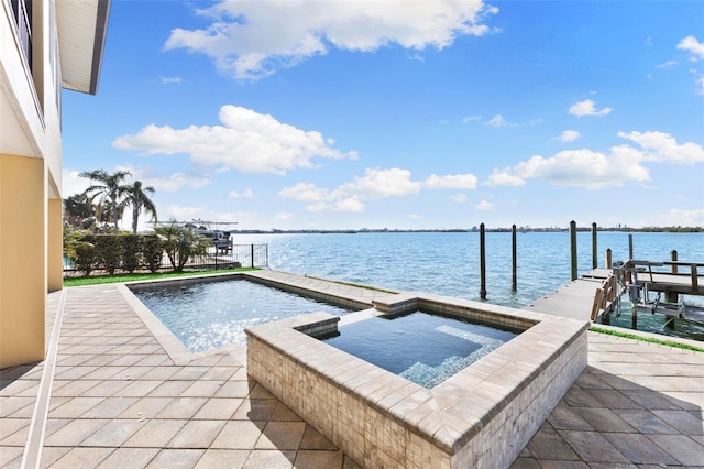 view of swimming pool featuring an in ground hot tub, a boat dock, and a water view