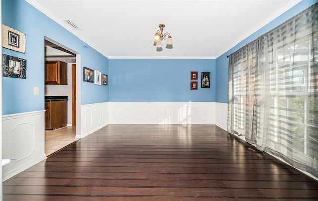 interior space featuring dark wood-type flooring, ornamental molding, and a chandelier