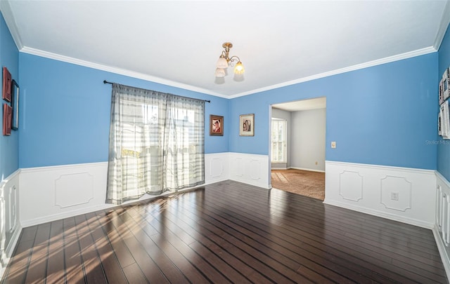 unfurnished room with crown molding, dark hardwood / wood-style flooring, and a notable chandelier