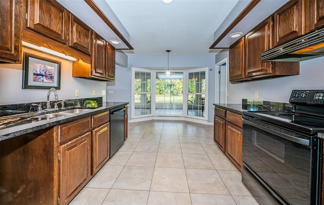 kitchen featuring extractor fan, decorative light fixtures, sink, light tile patterned floors, and black appliances