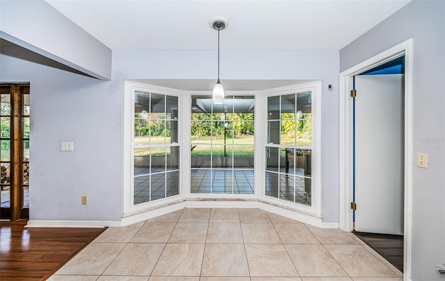 unfurnished dining area featuring light tile patterned flooring