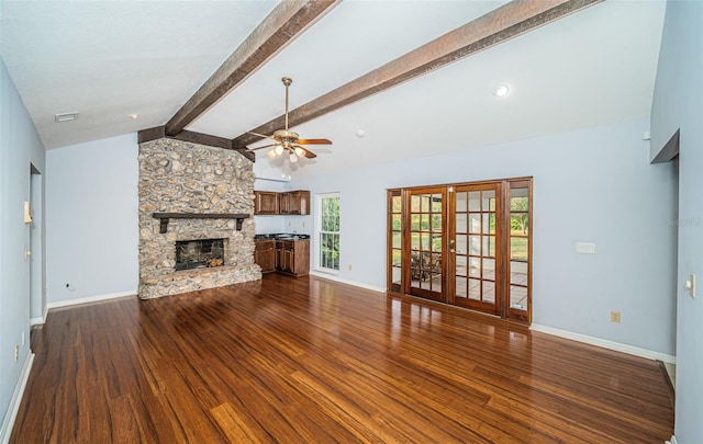 unfurnished living room featuring french doors, vaulted ceiling with beams, wood-type flooring, ceiling fan, and a fireplace