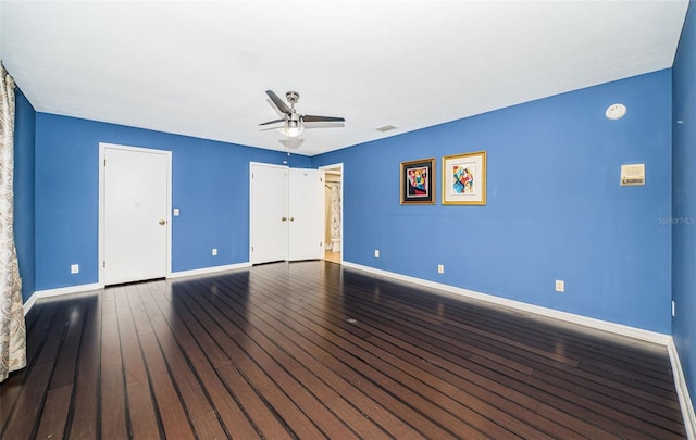 spare room featuring wood-type flooring and ceiling fan