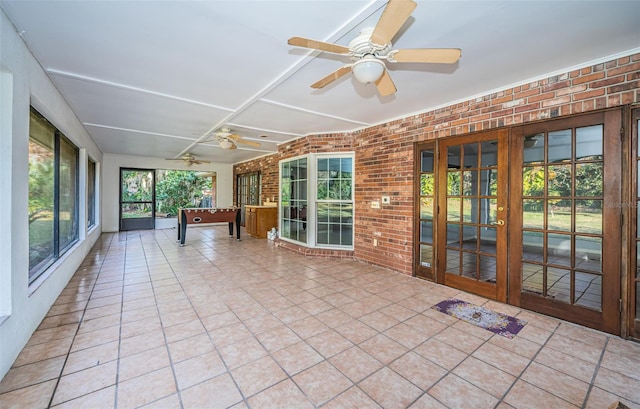 unfurnished sunroom featuring french doors and ceiling fan