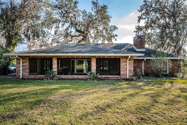 back of house featuring a lawn