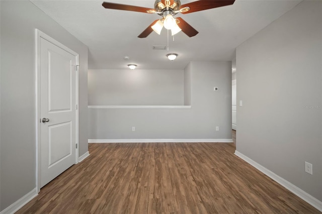 empty room with dark wood-type flooring and ceiling fan